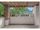 Covered patio space showcasing brick pillars and concrete flooring at 409 W 8Th St, Charlotte, NC 28202