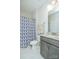 Neutral bathroom with a gray vanity, granite countertop, and a shower with blue patterned shower curtain at 424 Cassia Ct, Fort Mill, SC 29708