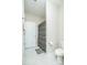 Bright bathroom features a neutral color palette, geometric shower curtain, and tile flooring at 424 Cassia Ct, Fort Mill, SC 29708