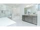 Elegant bathroom featuring a soaking tub, glass-enclosed shower, and a stylish gray double vanity with granite countertops at 424 Cassia Ct, Fort Mill, SC 29708
