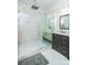 Bathroom featuring glass shower with sleek fixtures, bench, and modern vanity at 424 Cassia Ct, Fort Mill, SC 29708