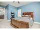 Bedroom with blue walls, wood furniture, ceiling fan, and connecting bath entry at 424 Cassia Ct, Fort Mill, SC 29708