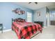 Cozy bedroom featuring blue walls, plush carpet, and a comfy bed with red plaid blanket at 424 Cassia Ct, Fort Mill, SC 29708