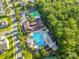 Aerial view of the community pool and clubhouse area with mature landscaping and ample parking at 424 Cassia Ct, Fort Mill, SC 29708