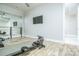 Bright exercise room with ballet bar, mounted TV, and modern fitness equipment on wood floors at 424 Cassia Ct, Fort Mill, SC 29708