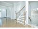 Bright foyer featuring hardwood floors, staircase with wood and iron railing, and elegant trim at 424 Cassia Ct, Fort Mill, SC 29708