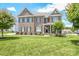 Charming brick home featuring a manicured lawn, tasteful landscaping, and a welcoming front porch at 424 Cassia Ct, Fort Mill, SC 29708