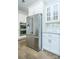 Kitchen area features stainless steel refrigerator, double ovens, and white cabinets at 424 Cassia Ct, Fort Mill, SC 29708