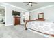 Bright main bedroom with ceiling fan, dresser, bathroom access, and a large bed at 424 Cassia Ct, Fort Mill, SC 29708