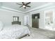 Spacious main bedroom featuring a tray ceiling, fan, and a view into the ensuite at 424 Cassia Ct, Fort Mill, SC 29708