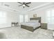 Large main bedroom with tray ceiling, ceiling fan, and plantation shutters at 424 Cassia Ct, Fort Mill, SC 29708