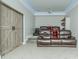 Home theater with a large screen, leather recliners, and a rustic sliding barn door at 424 Cassia Ct, Fort Mill, SC 29708
