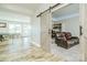 Spacious recreation room with modern wood floors and barn door leading to the media room at 424 Cassia Ct, Fort Mill, SC 29708