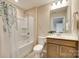 Bathroom with a shower-tub combo, a wood vanity, and neutral decor at 4511 Middlebury Ln, Fort Mill, SC 29715