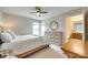 Bright bedroom with a decorative dresser, a stylish mirror and an attached bathroom at 4511 Middlebury Ln, Fort Mill, SC 29715