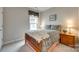 Cozy bedroom features patterned bedding, a window with valance, and carpeted floors at 4511 Middlebury Ln, Fort Mill, SC 29715