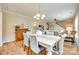 Open-concept dining area, neutral walls and decor that flows seamlessly into the living room and kitchen at 4511 Middlebury Ln, Fort Mill, SC 29715