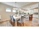 Charming dining area with a white table and modern chairs is open to the kitchen at 4511 Middlebury Ln, Fort Mill, SC 29715
