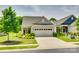 Charming home featuring a manicured lawn, lush landscaping, and an attached two-car garage at 4511 Middlebury Ln, Fort Mill, SC 29715