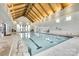 Bright indoor pool area with vaulted ceilings, expansive windows, and clear swimming lanes at 4511 Middlebury Ln, Fort Mill, SC 29715