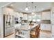 Bright kitchen features stainless steel appliances, granite counters, and a large center island with pendant lighting at 4511 Middlebury Ln, Fort Mill, SC 29715