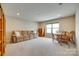 Spacious living room featuring a comfortable sofa and a dining area by a window at 4511 Middlebury Ln, Fort Mill, SC 29715