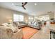 Inviting living room with hardwood floors, ceiling fan and open view to the modern, bright kitchen at 4511 Middlebury Ln, Fort Mill, SC 29715