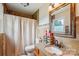 Charming bathroom with granite countertops, tiled walls, and a shower with curtain at 4527 Marshall Ct, Monroe, NC 28110