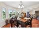 Charming dining area with natural light, hardwood floors, and a view of the neighborhood, great for Gathering at 4527 Marshall Ct, Monroe, NC 28110