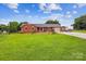 Beautiful brick home on a large, green lot with mature trees and a long driveway at 4527 Marshall Ct, Monroe, NC 28110