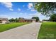 Inviting brick home featuring an extended driveway and well-maintained landscaping at 4527 Marshall Ct, Monroe, NC 28110