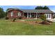 Charming brick home featuring a manicured front yard, covered porch, and inviting curb appeal at 4527 Marshall Ct, Monroe, NC 28110