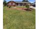 Well-maintained brick home with a spacious front yard featuring lush green grass and mature landscaping at 4527 Marshall Ct, Monroe, NC 28110