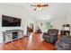 Spacious living room with hardwood floors, a vaulted ceiling, and a large entertainment center at 4527 Marshall Ct, Monroe, NC 28110