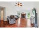Bright living room with hardwood floors, a brick fireplace, and vaulted ceilings at 4527 Marshall Ct, Monroe, NC 28110