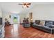 Inviting living room featuring gleaming hardwood floors, vaulted ceiling, and a comfortable seating arrangement at 4527 Marshall Ct, Monroe, NC 28110