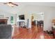 Open-concept living space featuring hardwood floors, a fireplace, and a seamless flow into the dining area at 4527 Marshall Ct, Monroe, NC 28110