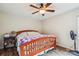 Cozy main bedroom featuring a wooden bed frame, ceiling fan and beautiful hardwood floors at 4527 Marshall Ct, Monroe, NC 28110