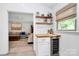 Wet bar area with white cabinets, wood counter and a wine fridge at 5929 Brookhaven Rd, Charlotte, NC 28210