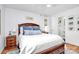 Bright bedroom with wood floors, white bedding, and a ceiling fan at 5929 Brookhaven Rd, Charlotte, NC 28210