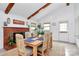 Charming dining area with a wood table, fireplace, and a jute rug at 5929 Brookhaven Rd, Charlotte, NC 28210