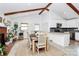 Bright dining area with vaulted ceilings, adjacent to an updated kitchen, creating a seamless living space at 5929 Brookhaven Rd, Charlotte, NC 28210