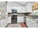 Bright kitchen featuring stainless steel appliances, tile backsplash and countertops at 5929 Brookhaven Rd, Charlotte, NC 28210