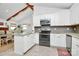 Modern kitchen with stainless appliances, granite counters, and white cabinetry at 5929 Brookhaven Rd, Charlotte, NC 28210