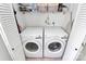Bright laundry room with washer and dryer, and shelves for supplies at 5929 Brookhaven Rd, Charlotte, NC 28210
