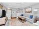 Bright living room with large painting, hardwood floors, comfortable seating, and abundant natural light at 5929 Brookhaven Rd, Charlotte, NC 28210