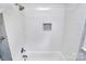 Subway tiled shower includes white tile and a tiled shower niche at 5929 Brookhaven Rd, Charlotte, NC 28210