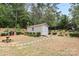 Backyard shed with garden and green surroundings, providing storage and enhancing the natural landscape at 6010 Hawk View Rd, Waxhaw, NC 28173