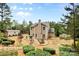 Extensive backyard with fire pit, lush landscaping, storage shed, and privacy fence at 6010 Hawk View Rd, Waxhaw, NC 28173