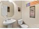 Clean powder room featuring a white sink and toilet with decorative wall art giving it a patriotic theme at 6010 Hawk View Rd, Waxhaw, NC 28173